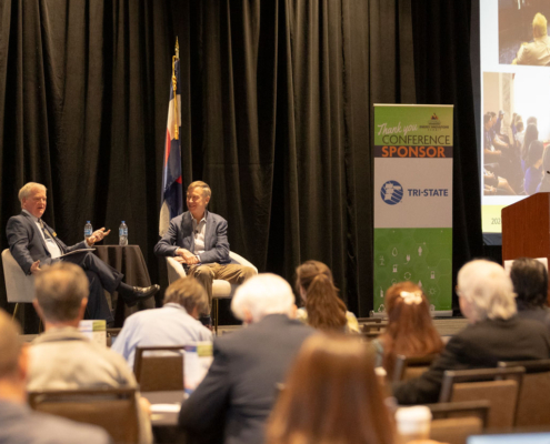 US Senator John Hickenlooper and CREA Executive Director Kent Singer chat during the CREA Energy Innovations Summit.