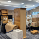 Office space filled with packed boxes and disassembled furniture during a relocation.